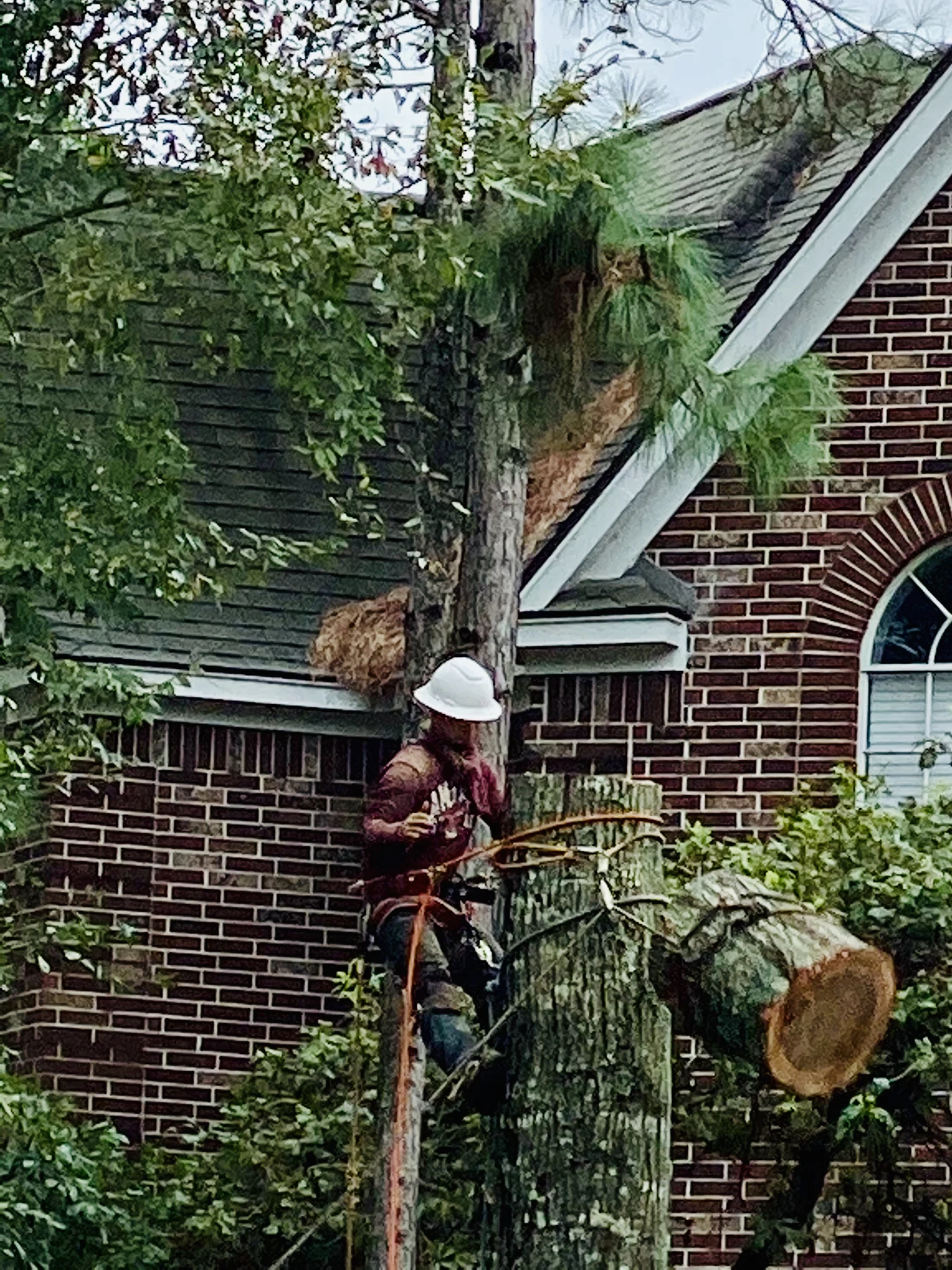 A JJ Garcia crew member working near a home